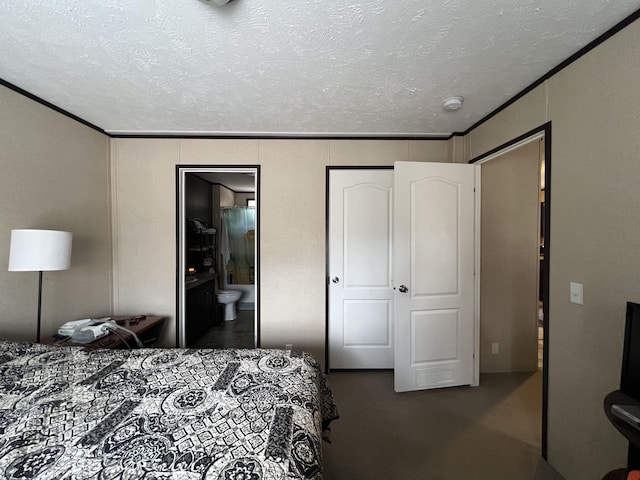 bedroom with ornamental molding, carpet, a textured ceiling, and connected bathroom