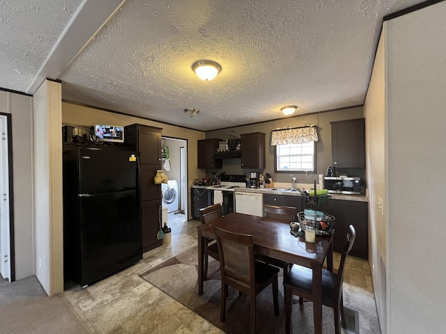 dining space featuring washer / dryer, a textured ceiling, and sink