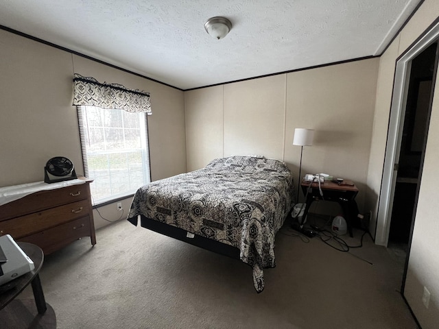 bedroom featuring carpet floors, ornamental molding, and a textured ceiling