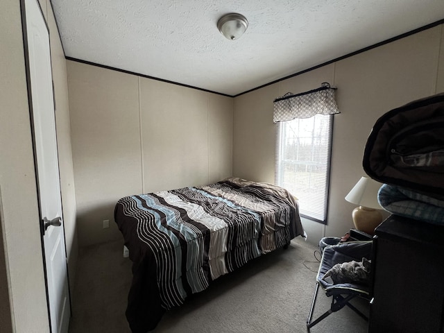 carpeted bedroom featuring crown molding and a textured ceiling
