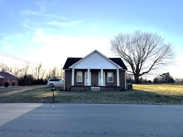 view of front of home featuring covered porch and a front yard