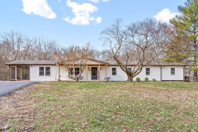 ranch-style home featuring a carport and a front yard