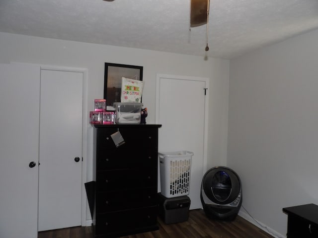 miscellaneous room featuring dark hardwood / wood-style flooring and a textured ceiling