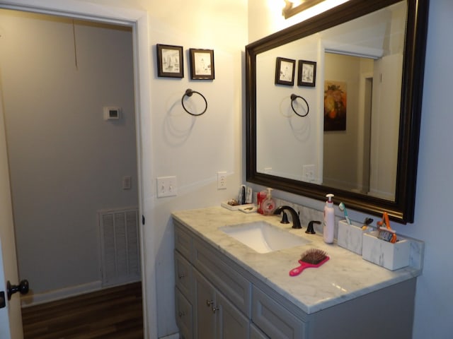 bathroom featuring hardwood / wood-style floors and vanity