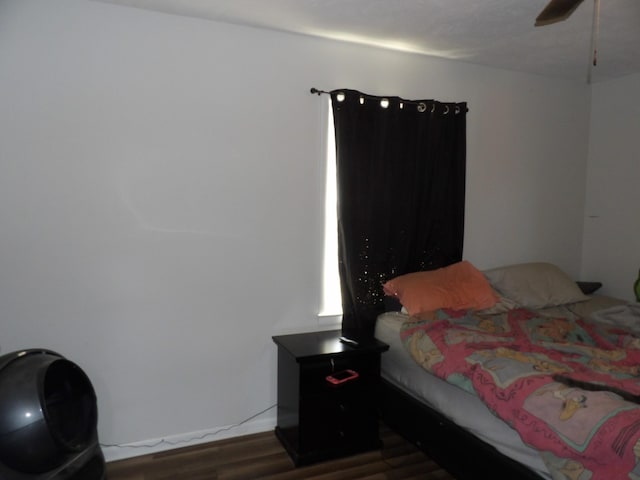 bedroom with ceiling fan and dark wood-type flooring