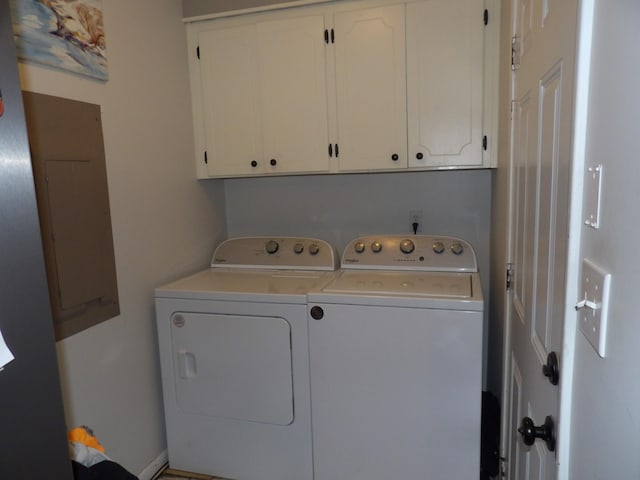 washroom featuring cabinets and separate washer and dryer