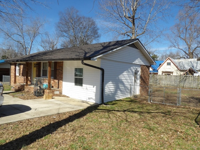 rear view of property featuring a patio area, a yard, and covered porch