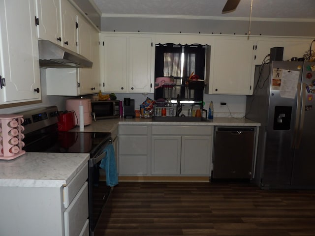 kitchen with stainless steel appliances, dark hardwood / wood-style flooring, ornamental molding, sink, and white cabinetry