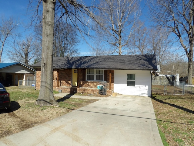 ranch-style house featuring a front yard and a carport