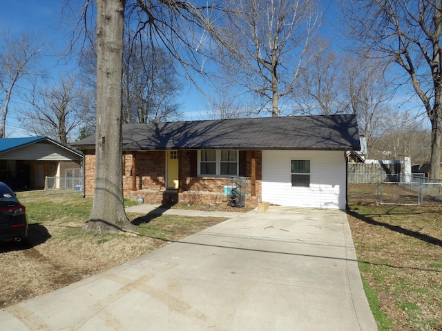 ranch-style house featuring a carport and a front lawn