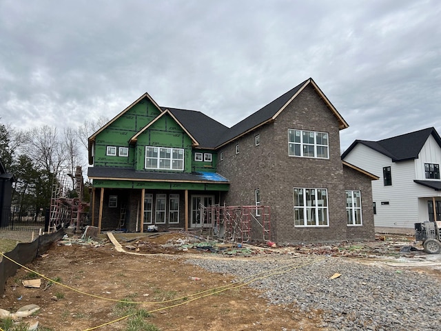 view of front of property featuring brick siding and covered porch