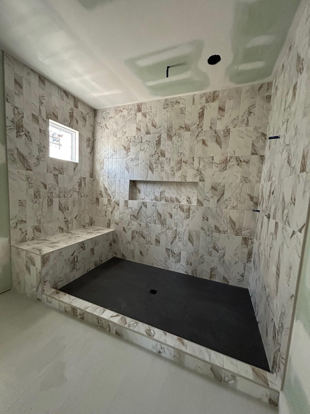 bathroom with tiled shower