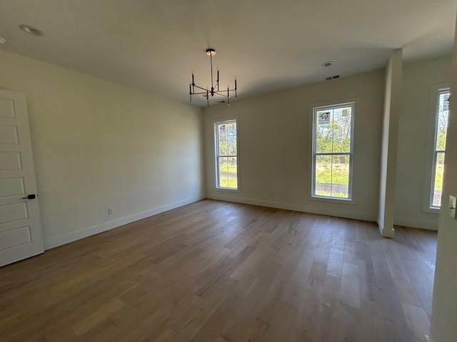 4928 Elmview Ct, Smyrna, TN 37167 - unfurnished dining area with a chandelier, wood finished floors, visible vents, and baseboards