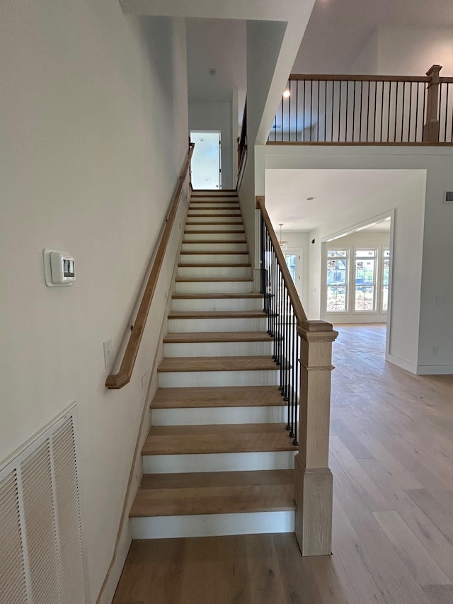 4928 Elmview Ct, Smyrna, TN 37167 - stairs featuring baseboards, wood finished floors, visible vents, and a high ceiling