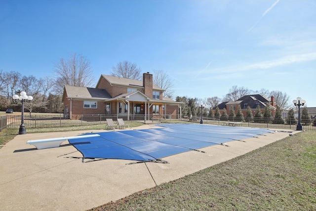 view of pool featuring a patio and a lawn