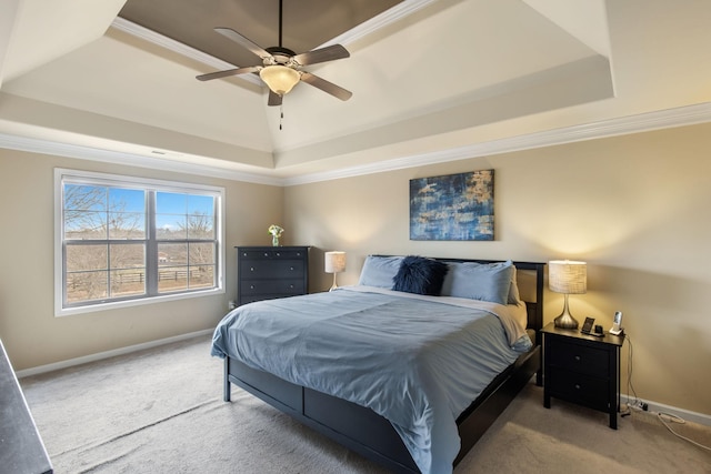 bedroom featuring ceiling fan, carpet floors, crown molding, and a raised ceiling