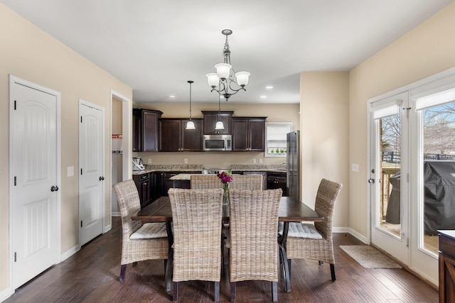 dining area featuring an inviting chandelier and dark hardwood / wood-style floors