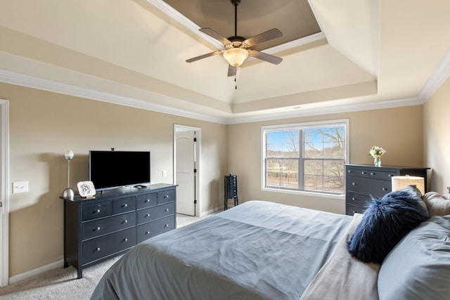 bedroom featuring light carpet, crown molding, ceiling fan, and a raised ceiling