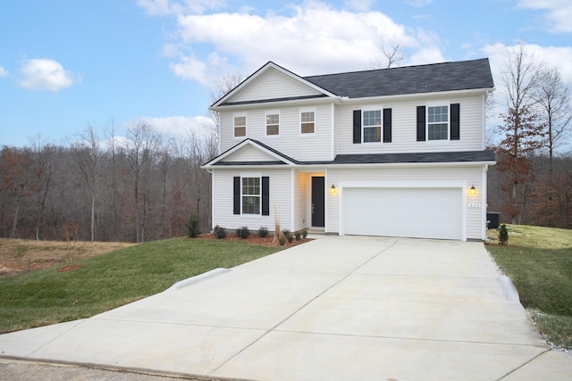 view of property featuring a front lawn and a garage