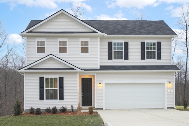 view of front of property with a front lawn and a garage