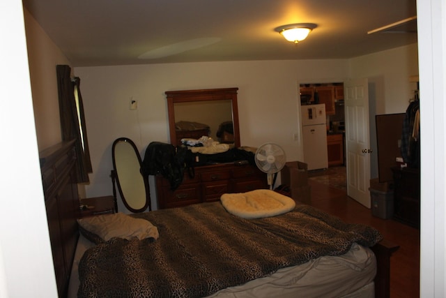 bedroom featuring white refrigerator