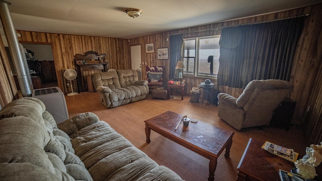 living room with hardwood / wood-style flooring and wooden walls