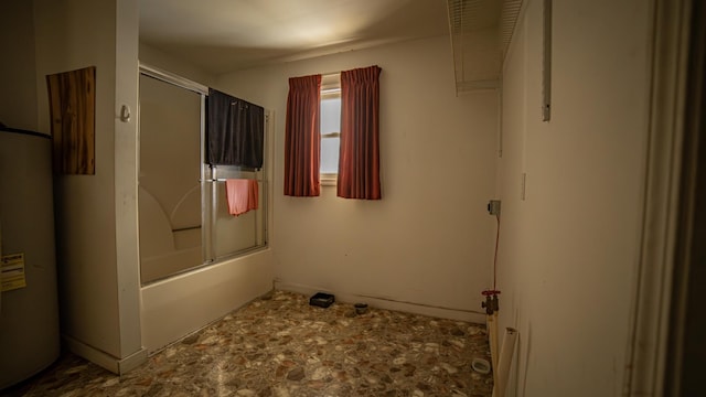 bathroom featuring shower / bath combination with glass door