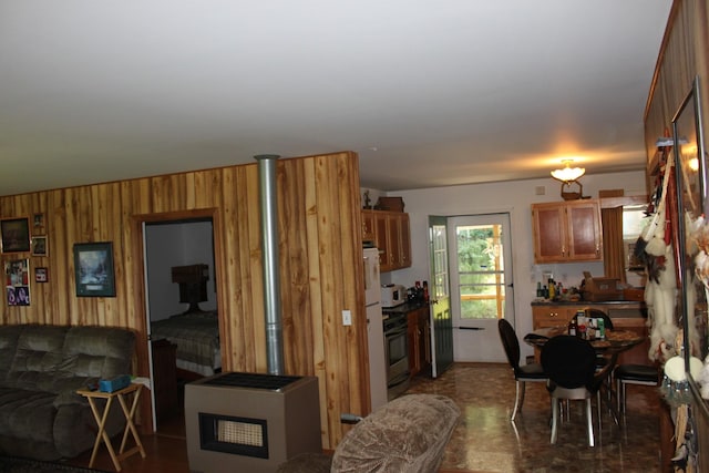 interior space with stainless steel range oven and wood walls