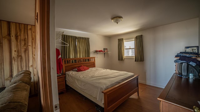 bedroom with dark wood-type flooring