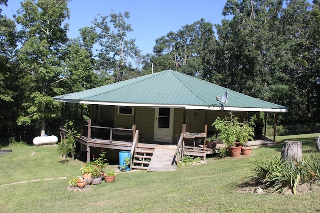 back of house with a deck and a yard