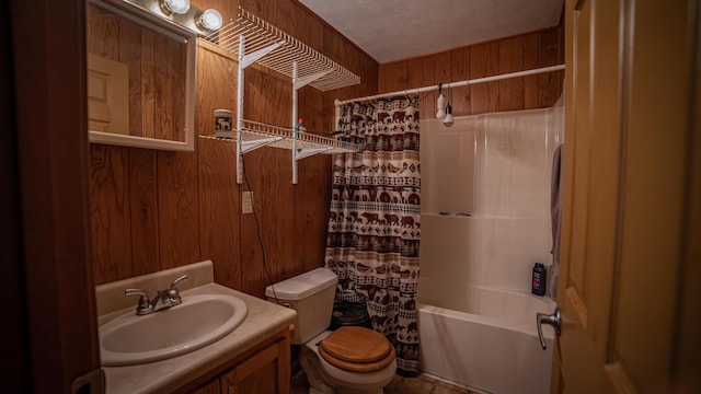 full bathroom with toilet, wood walls, vanity, and shower / tub combo