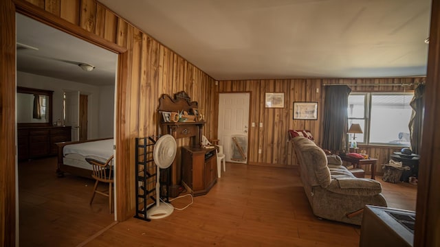 interior space with hardwood / wood-style flooring and wooden walls