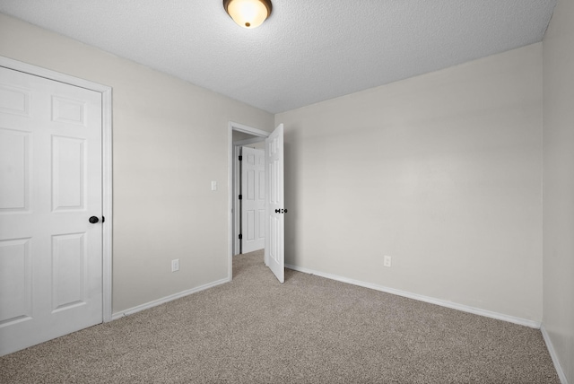 unfurnished bedroom featuring carpet floors and a textured ceiling