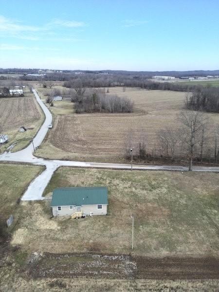 birds eye view of property with a rural view