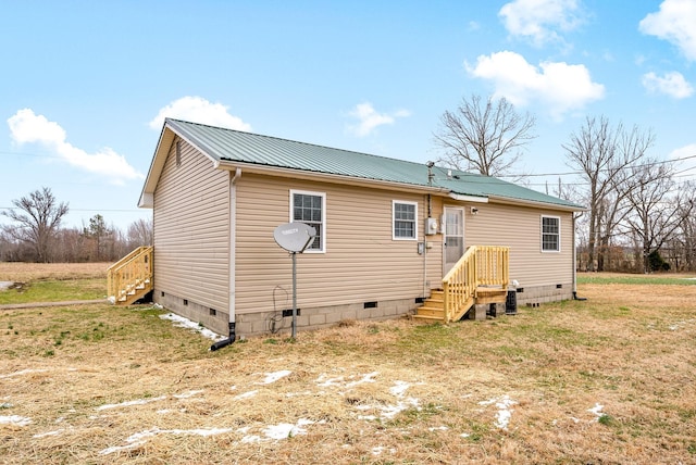 rear view of property featuring a yard