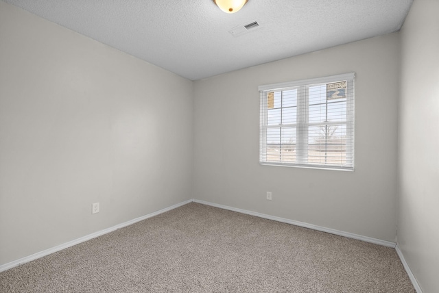 spare room with carpet and a textured ceiling