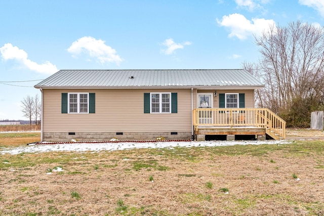 rear view of house with a yard and a wooden deck