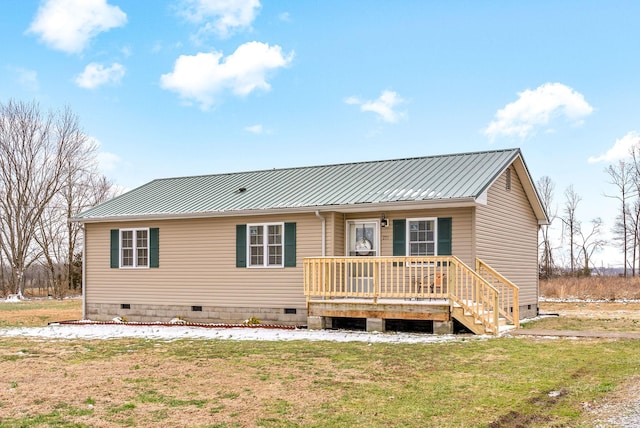 rear view of property featuring a lawn and a wooden deck