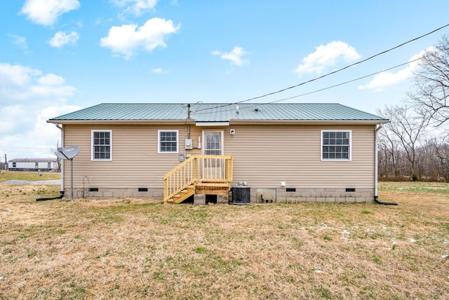 rear view of house with a yard and central AC