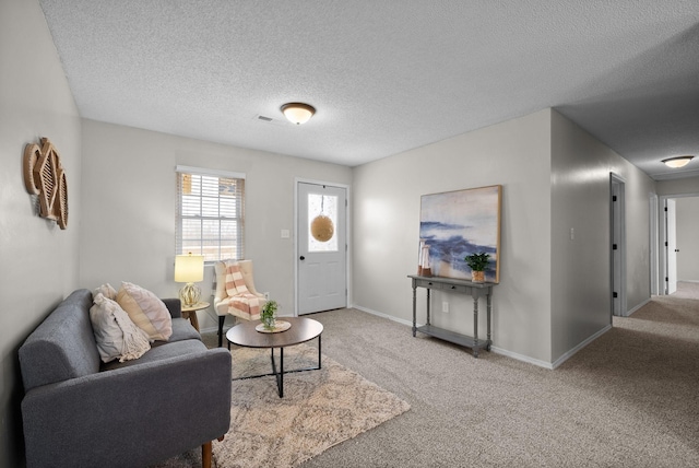 entryway featuring a textured ceiling and carpet flooring