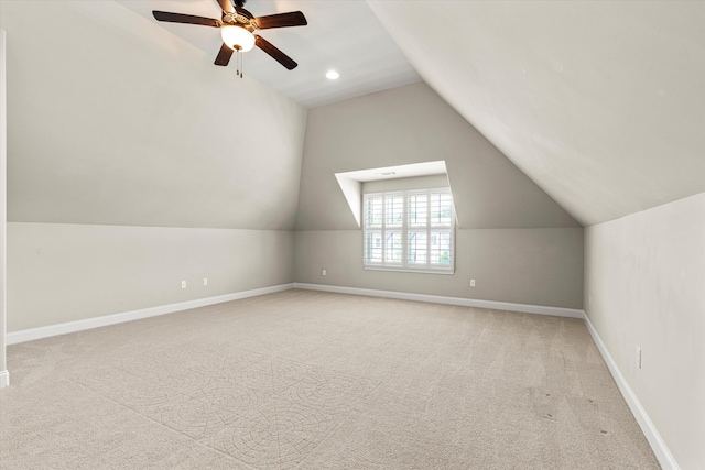 additional living space with ceiling fan, light colored carpet, and lofted ceiling