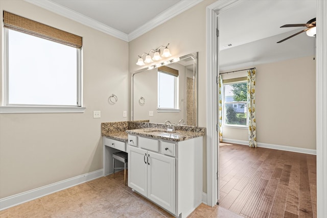 bathroom featuring ornamental molding, vanity, and ceiling fan