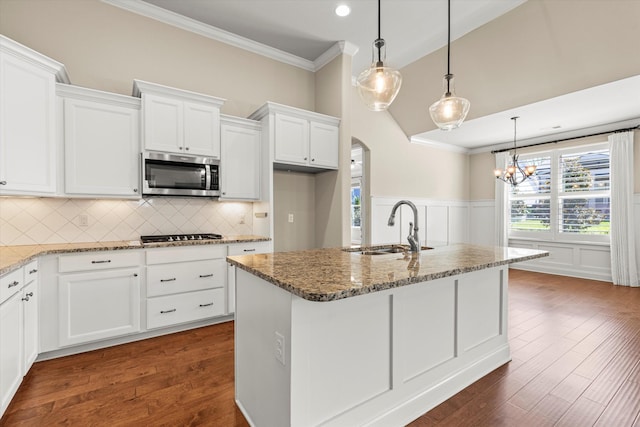 kitchen with sink, a kitchen island with sink, white cabinetry, and stainless steel appliances