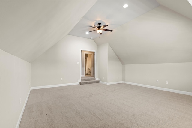 bonus room with light carpet, lofted ceiling, and ceiling fan