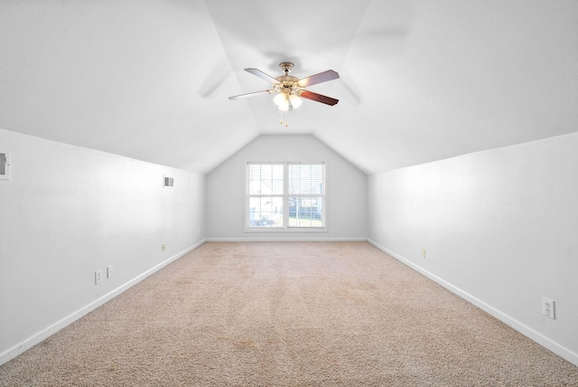 bonus room with ceiling fan, vaulted ceiling, and light carpet