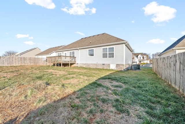 back of house featuring a yard, cooling unit, and a wooden deck