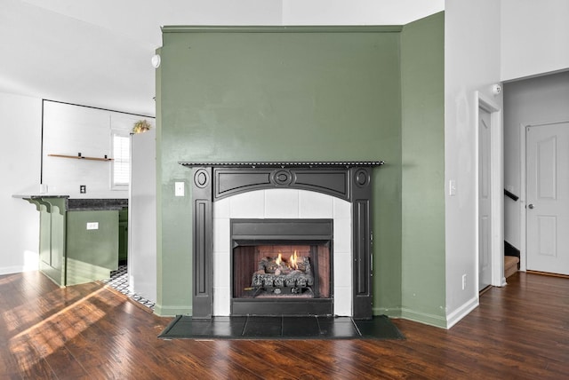 details with hardwood / wood-style flooring and a fireplace