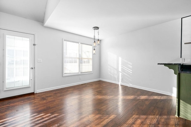 unfurnished living room featuring dark hardwood / wood-style floors