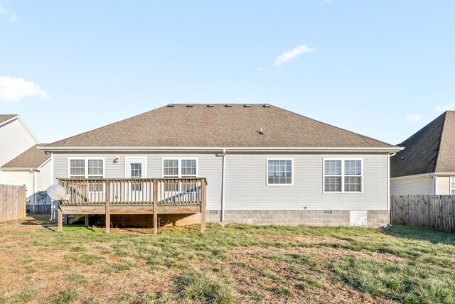 back of house featuring a yard and a wooden deck