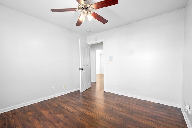 spare room with ceiling fan and dark hardwood / wood-style flooring